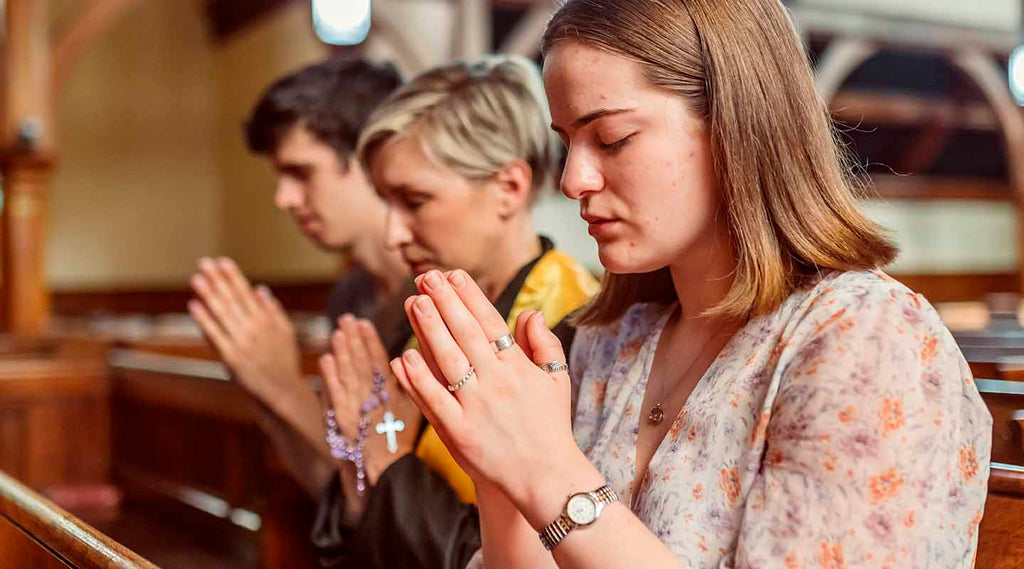 Thee people praying at the church