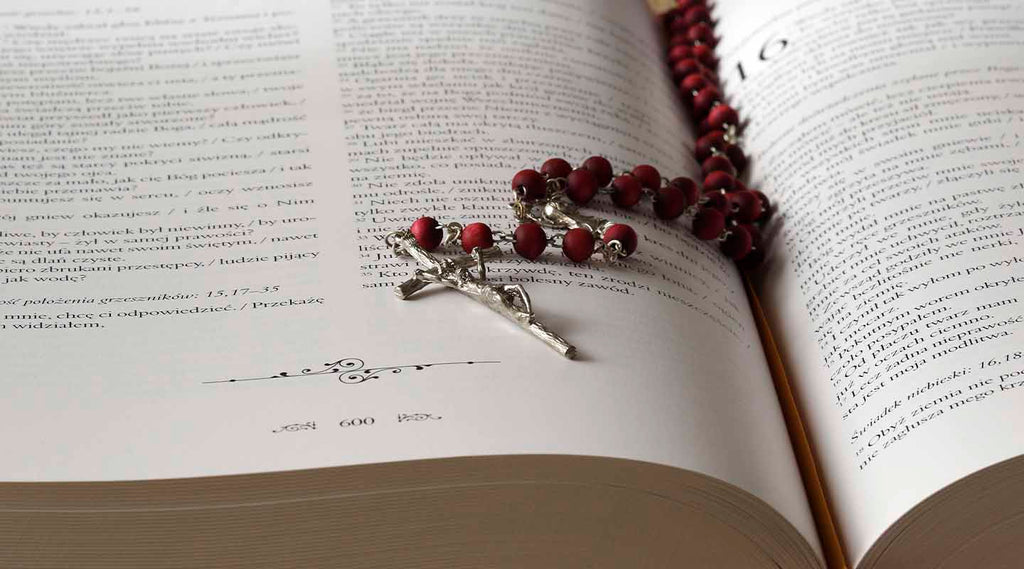 Red Rosary on the Bible